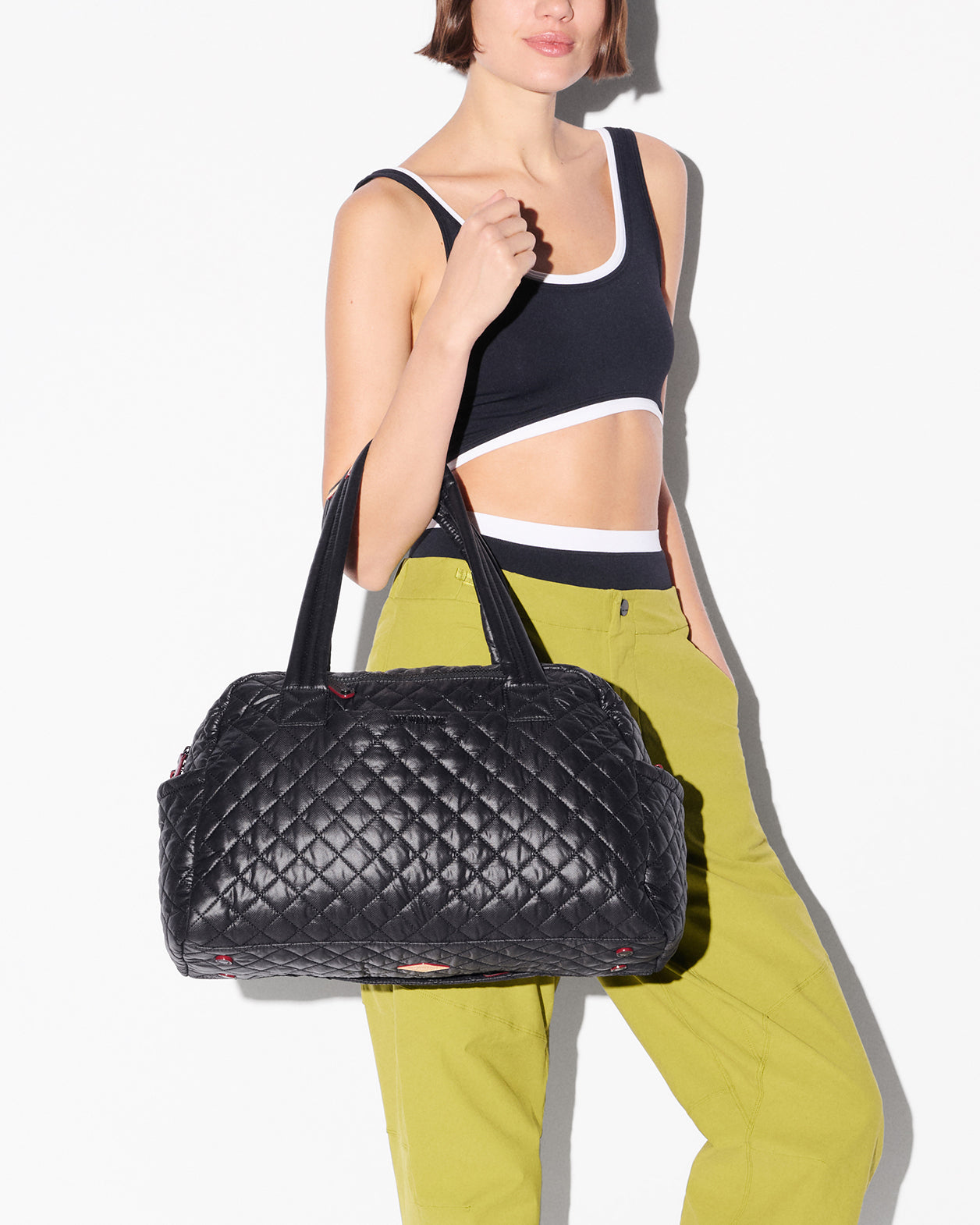 MZ Wallace Jimmy Deluxe duffel in black, carried by a model