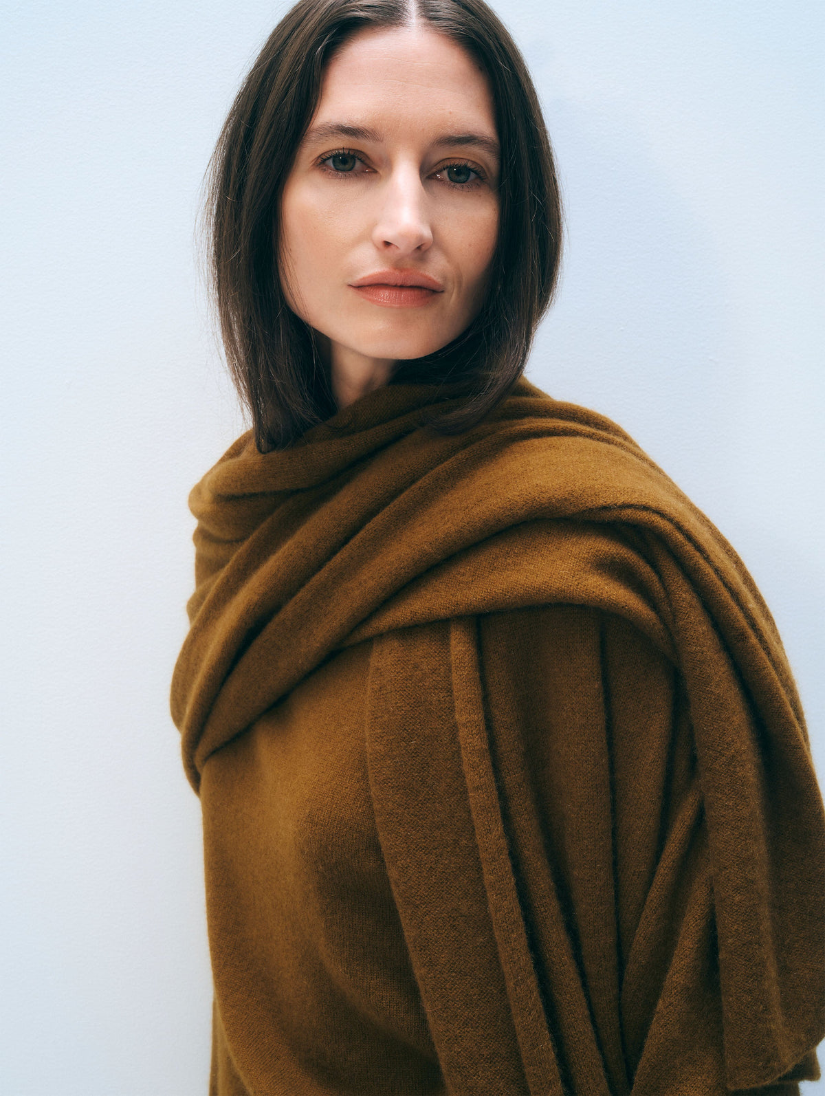 White + Warren Travel Wrap in Antique Gold, draped on model, close view