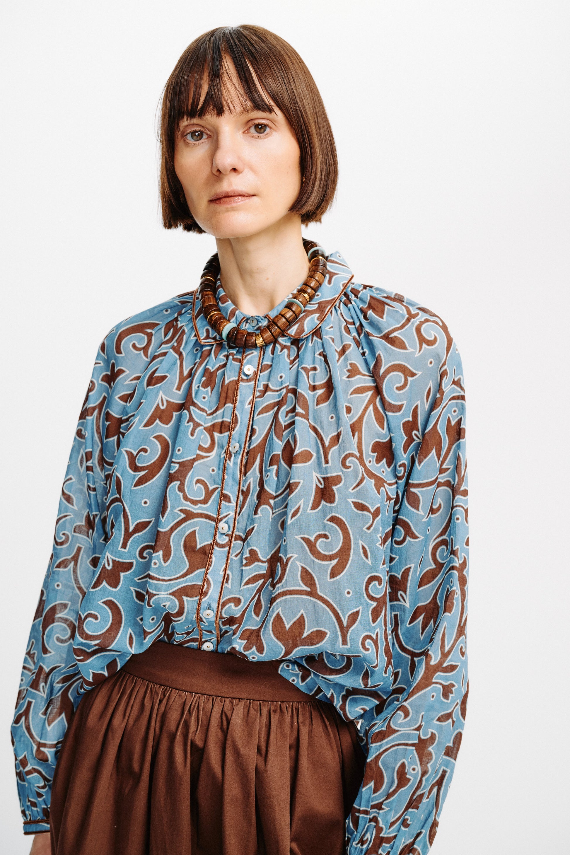 Carolina K Alice Top in Autumn Vine Blue, worn tucked into a skirt