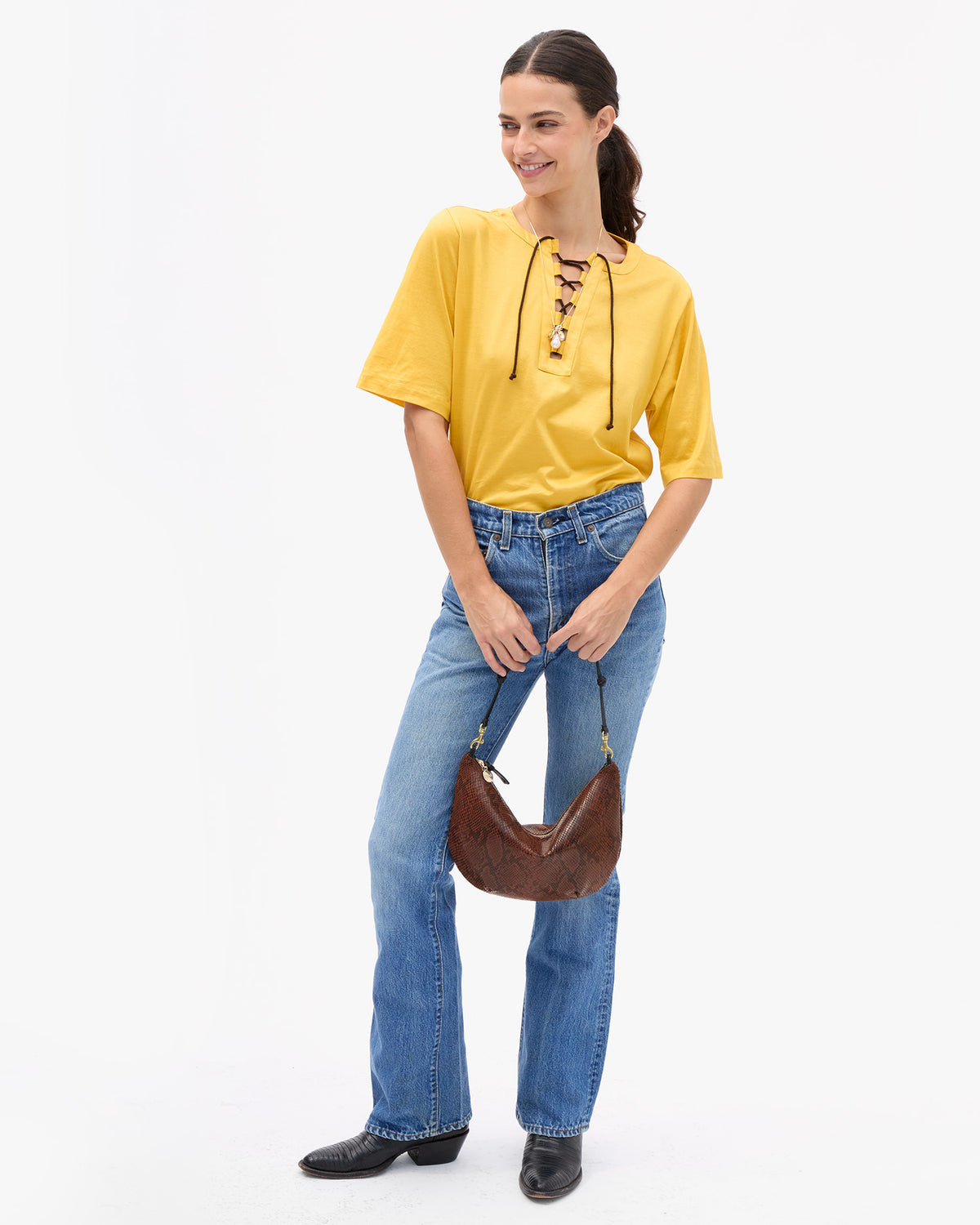 Clare V Lune Bag in Auburn Embossed Python held by a model