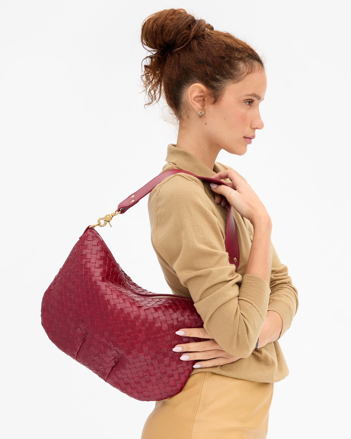 Clare V Moyen Messenger in Garnet Diagonal Woven, shown on model as a shoulder bag