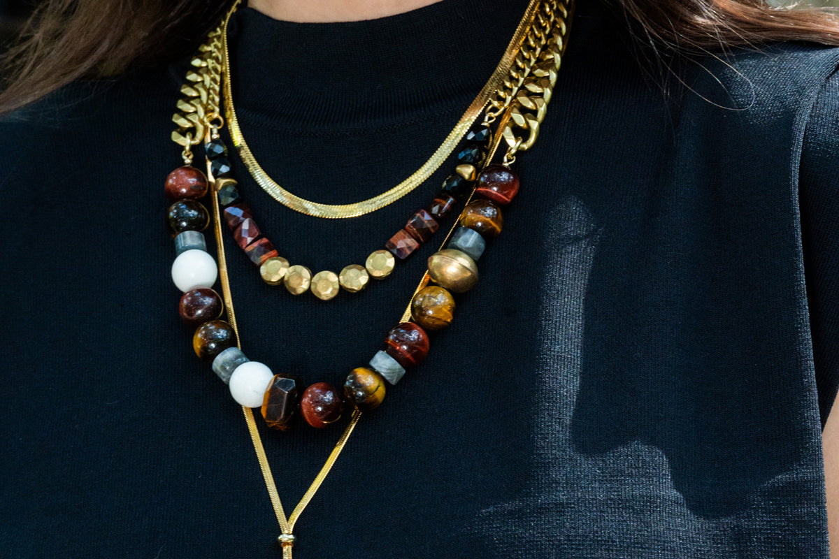 Rachel Nathan Red Tiger's Eye & Brass Sand Dollar necklace shown on model
