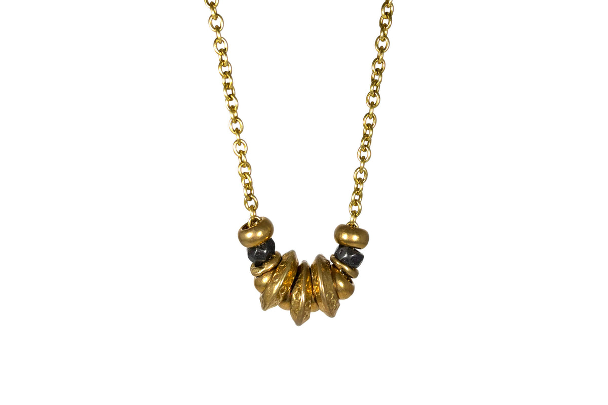 Rachel Nathan Wander Rings 2.0 necklace, full front view of sculpted Indian brass rings on a long brass oval chain