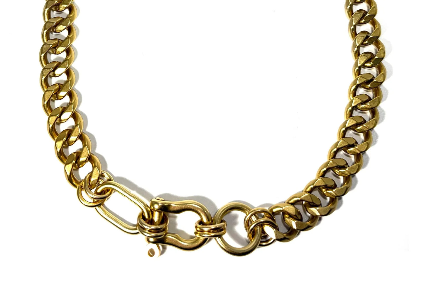 Rachel Nathan Shackle: Trio necklace, full front view of the brass shackle clasp joining three Perfect Curb chains